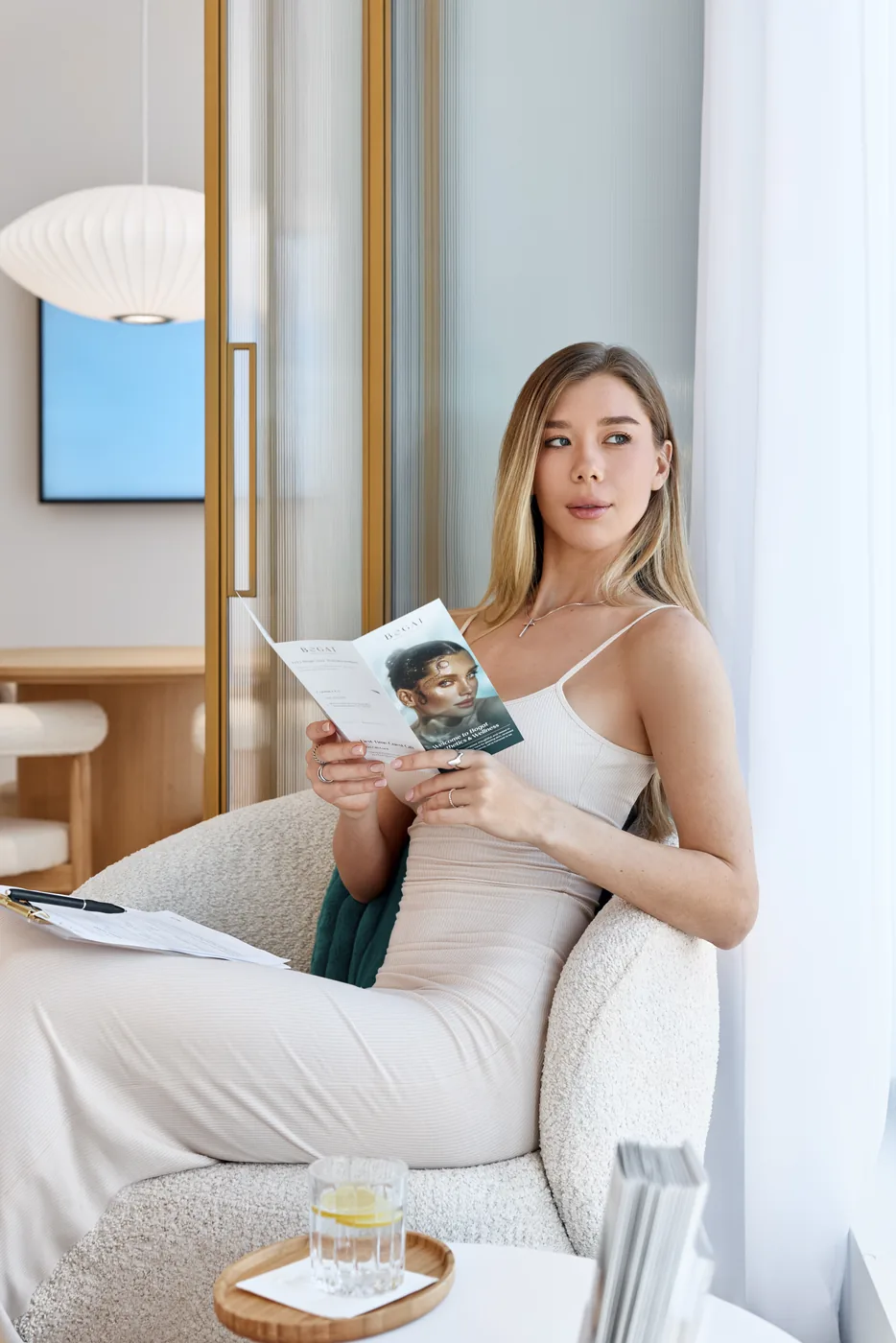 Client reviewing Bogat treatment information in the consultation lounge at Bogat Aesthetics & Wellness in Hallandale Beach, FL.