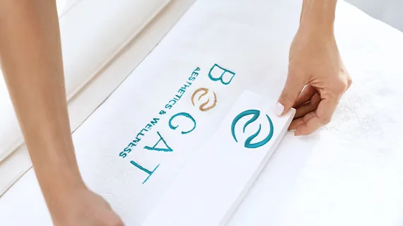 Aesthetician preparing a Bogat-branded treatment room before a HydraFacial in Hallandale Beach, FL